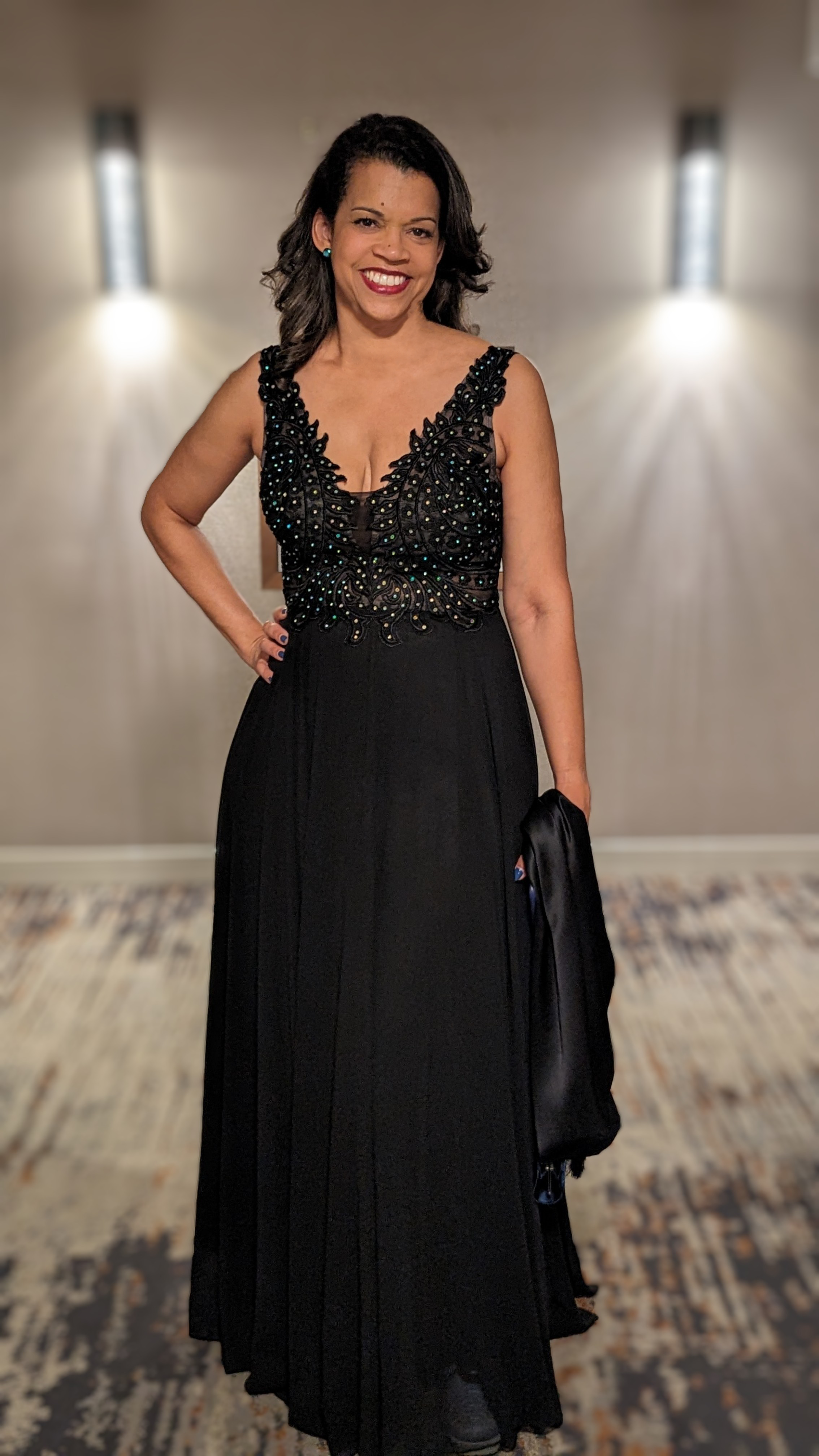 Dr. Shairi Turner smiling in a formal black evening gown at an event